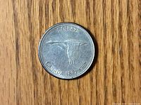 Reverse side showing flying Canada goose, denomination and dates