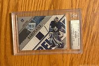 Front of encased Ed Belfour Nameplates jersey card showing player image, jersey swatch, serial number 15/40