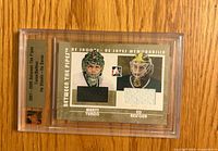 Front of encased card showing players, fabric swatches, series title