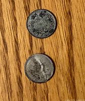 Both coins front view showing heavy wear