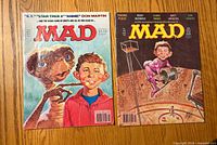 Front covers of both Mad magazines displayed side by side
