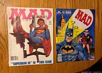 Front covers of both Mad magazines showing Superman III and Batman Forever parodies