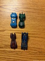 Top view of four Batmobile cars showing colour and design differences