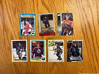 Fronts of all seven hockey cards laid out on table