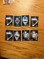 Fronts of eight Score The Mask cards laid out showing different mask artworks