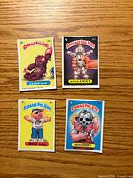 Front view of four Garbage Pail Kids cards: Teddy Bear, Stuck Chuck, Rod Wad, Bony Tony