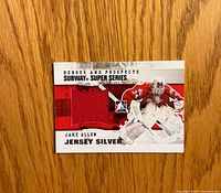 Front of Jake Allen Jersey Silver card with red jersey swatch