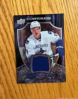 Front of Upper Deck Contours Club Crest Jake Virtanen jersey card showing player image and fabric swatch