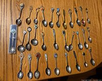 Overview of all souvenir spoons on table