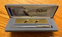 Open Quill presentation box showing pen and branding