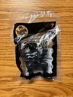Front of sealed Happy Meal Spider-Man toy showing McDonald’s logo, #7, and figure inside