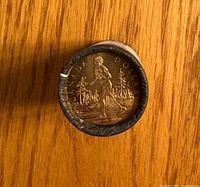End view of roll showing Terry Fox $1 coin reverse