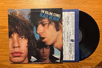 Front cover of The Rolling Stones Black and Blue LP with record partially visible