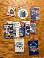 All items laid out showing pin, disc, card, schedules, patch and playing cards