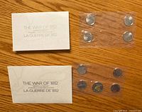 Overall view showing two insert cards and two sealed coin strips