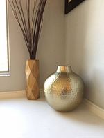 Wood and metal vases on windowsill