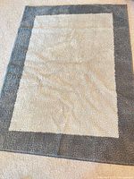 Full view cream rug with gray border