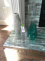 Four vases grouped on tiled hearth