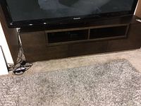 Front view of espresso TV stand beneath television