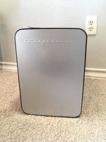 Front view showing brushed silver door with Frigidaire logo
