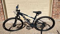 Full view of Trek Marlin 7 mountain bike leaning against garage door