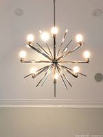 Fixture illuminated showing radial arms and bulbs