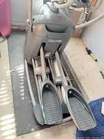 Full view of Octane elliptical base showing pedals and rails