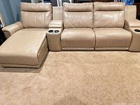 Front view of entire sectional showing loveseat, two chaises, and both consoles