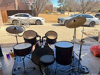 Full view of assembled red Pearl Forum drum set with cymbals and stool