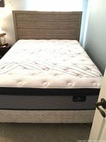 Full view of queen bed frame, headboard and mattress