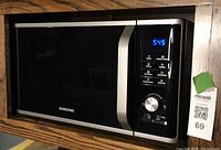 Front view of Samsung microwave installed in cabinet
