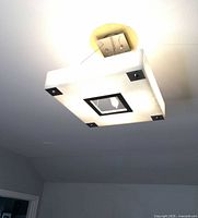 Overall view of square faux alabaster ceiling light fixture mounted to ceiling