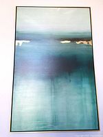 Front view of abstract canvas art in gold frame