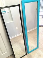 Both mirrors leaning against wall showing full view