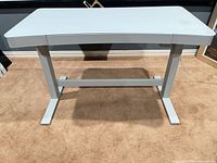 Front angled view of assembled white electronic sit/stand desk