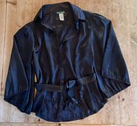 Blouse laid flat showing front, belt, sleeves, collar and tag