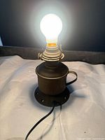 Lamp lit with bulb installed showing E26 socket and overall form
