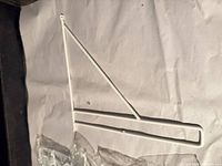 Single white metal PERSHULT bracket on packaging