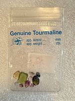 Clear pouch labeled Genuine Tourmaline showing all gemstones