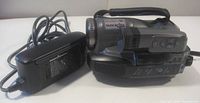 Panasonic camcorder with attached battery and charger unit shown