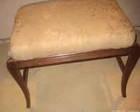 Overall view of wooden bench showing seat cushion and frame