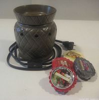 Ceramic warmer with cord, four wax discs visible