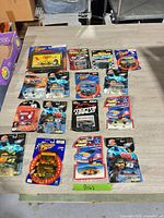 All sixteen carded die-cast cars laid out on table