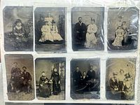 binder page showing eight antique tintype photographs