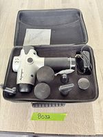 Massage gun with attachments and case overview