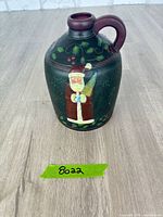 Front view showing Santa Claus artwork on jug