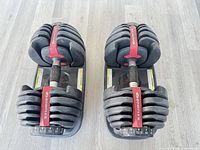 Top view of both Bowflex adjustable dumbbells in cradles