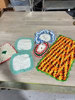 All six crocheted doilies laid out on table
