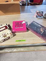 Three sealed board games on tabletop