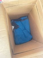 Blue moving blanket folded inside a cardboard box